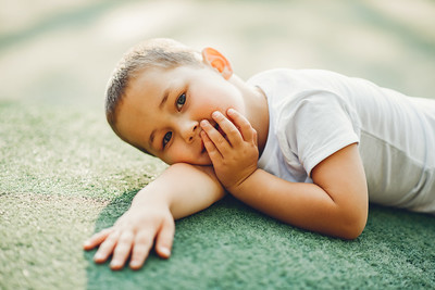 Smiling child lying in the sunshine