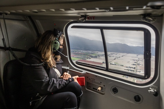 Minister Popham observing floods in Abbotsford from a helicopter